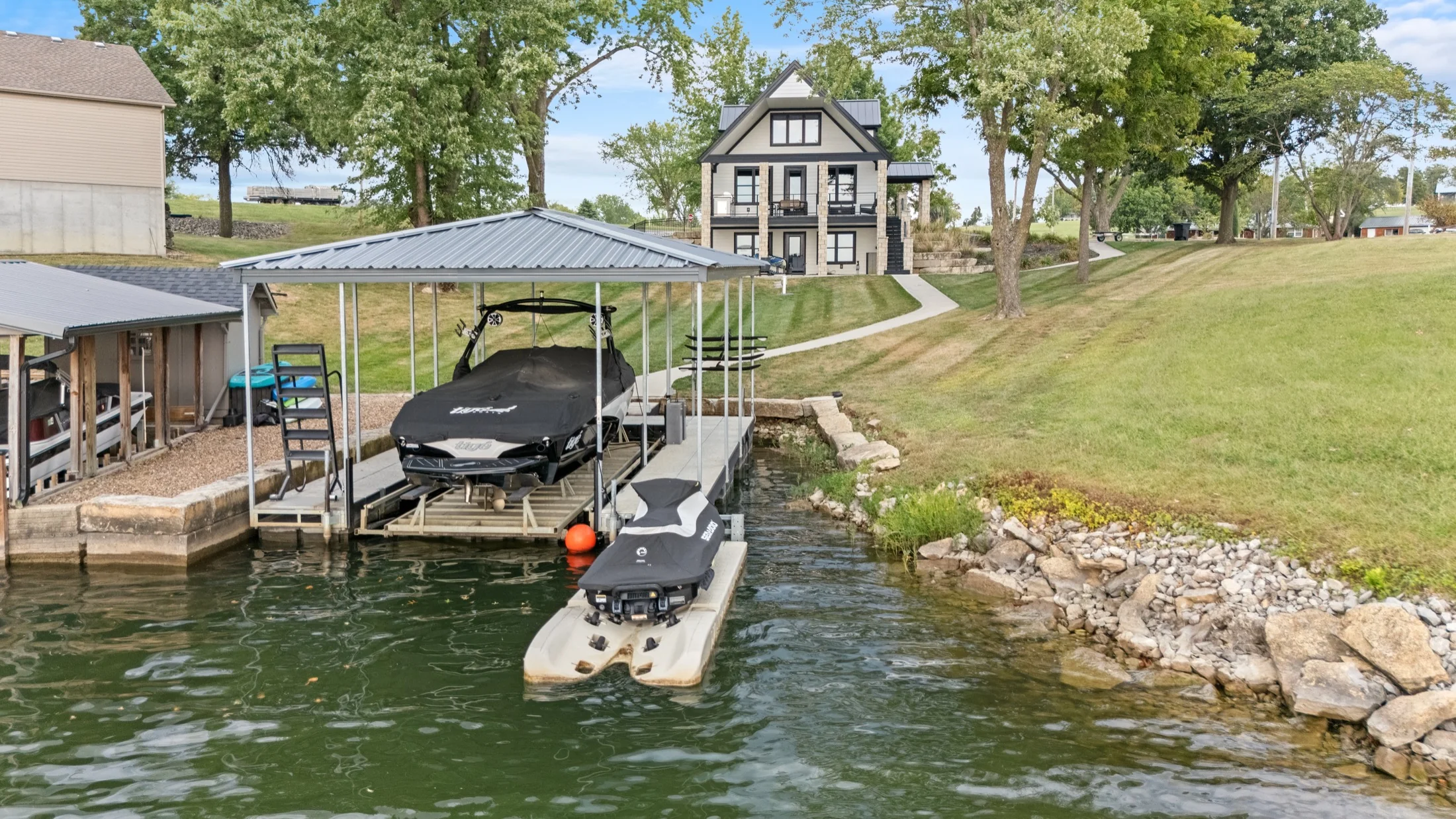 Aerial view of the home and its waterfront setting.