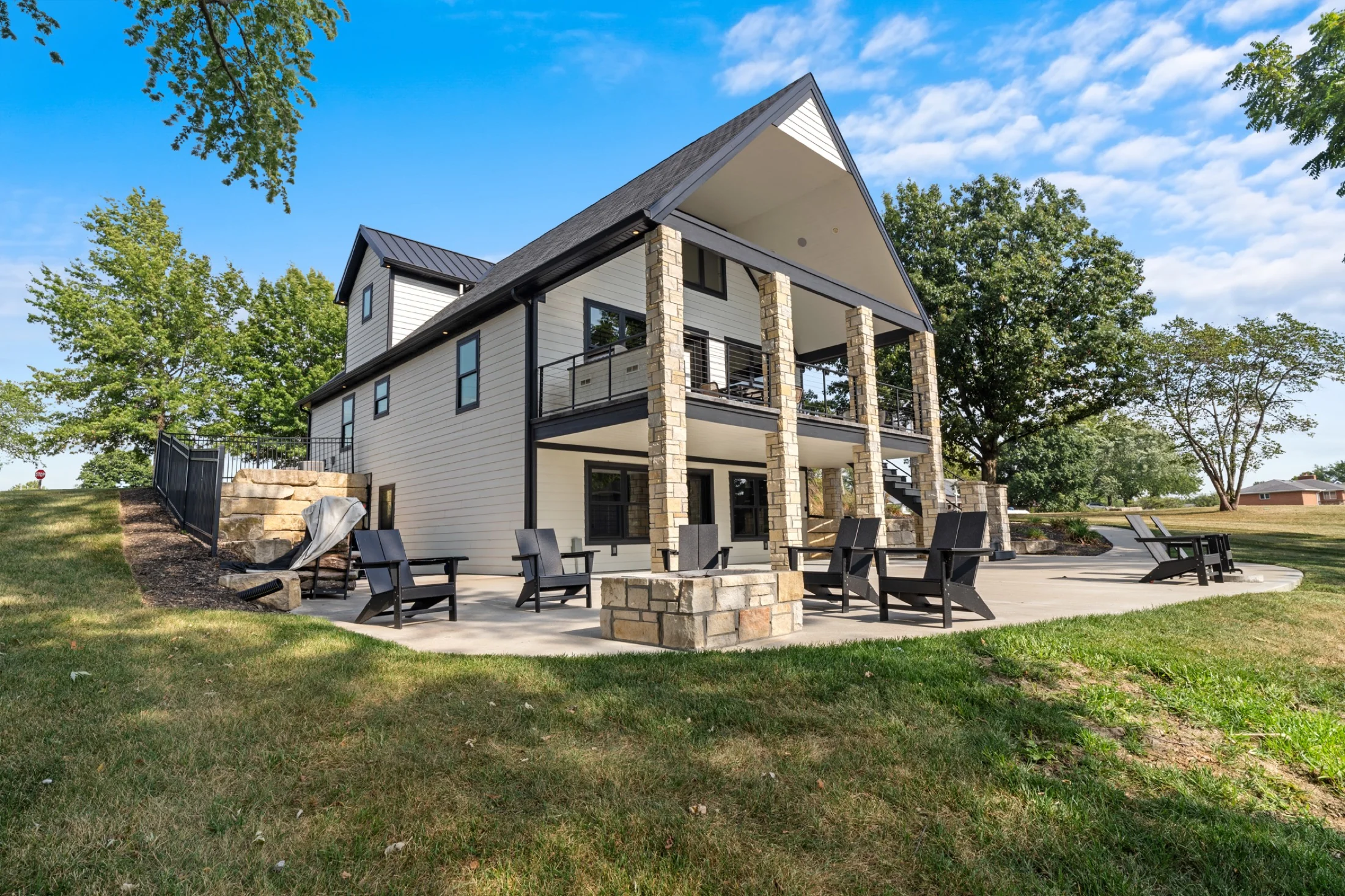 Gabled lake house and stone patio at 102 Angler Point.