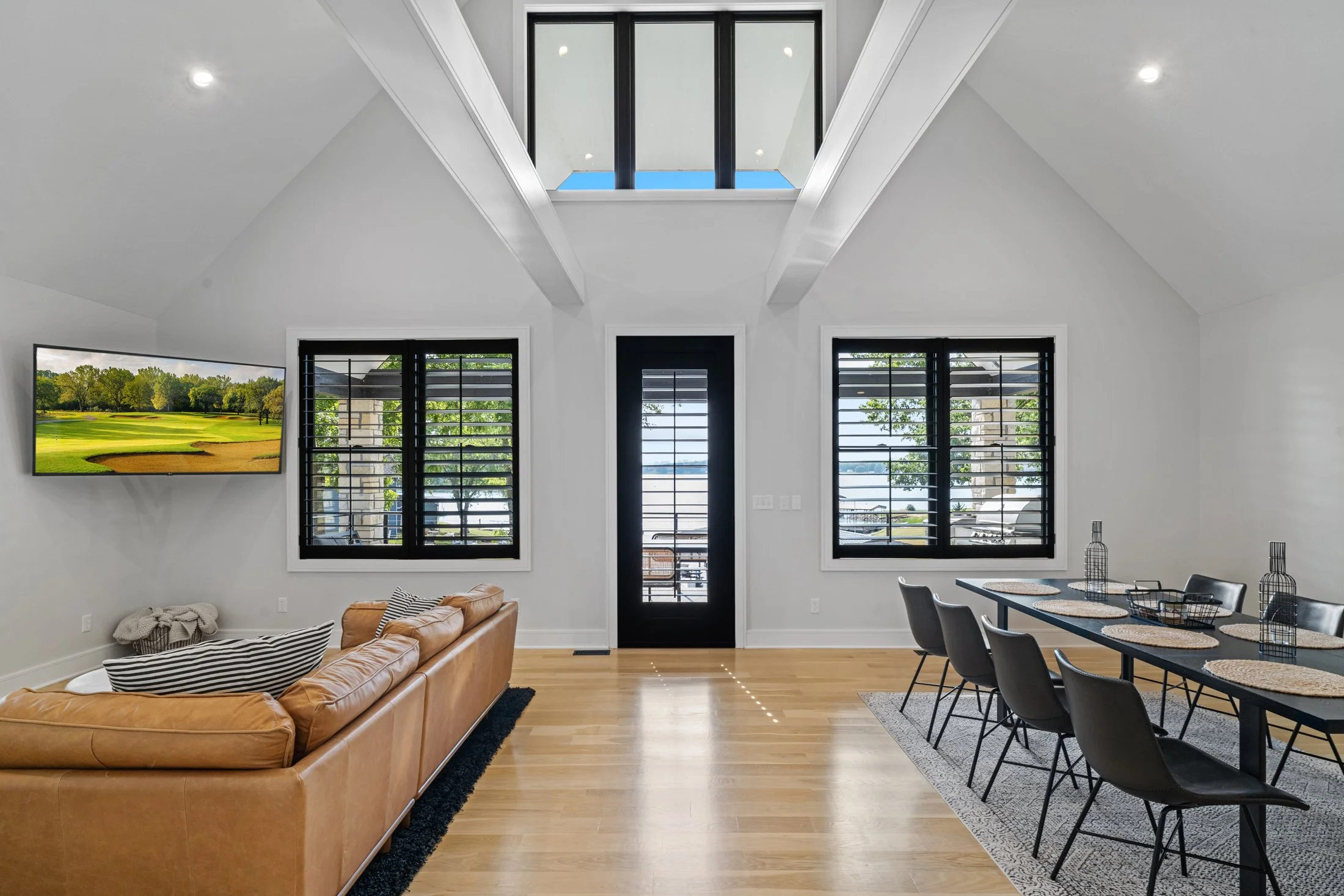 Vaulted living and dining room with lake views.