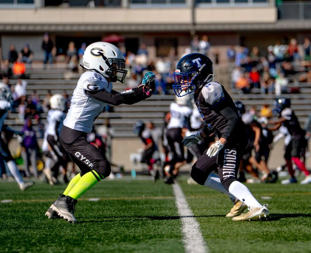 Two football players facing each other on the field.